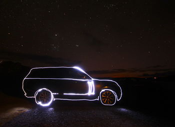 Illuminated car against sky at night