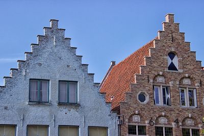 Low angle view of building against clear blue sky