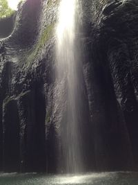 Scenic view of waterfall against sea