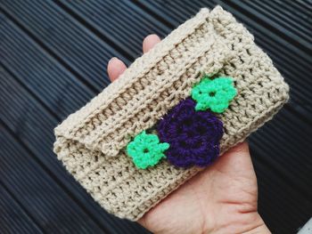 High angle view of woman hand holding woolen bag