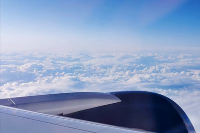 Airplane flying over cloudscape against sky