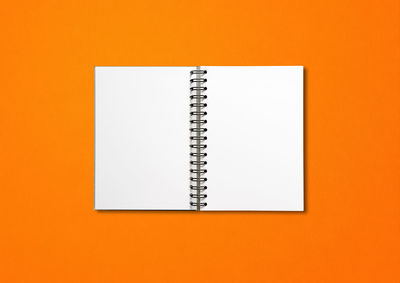 Close-up of open book against orange background