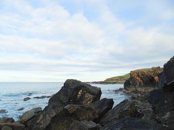 Rocks on beach against sky