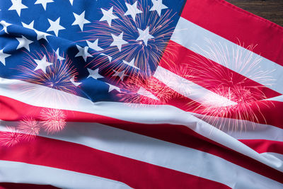 Double exposure of firework display and american flag