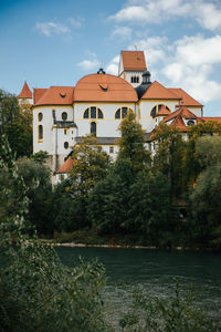 View of füssen abbey from river in bavarian alps, germany.