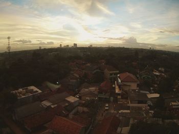 Aerial view of cityscape against sky during sunset