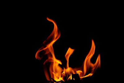 Close-up of fire burning over black background