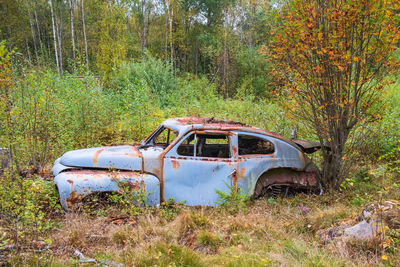 Abandoned car on field