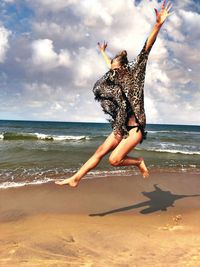 Woman jumping on beach