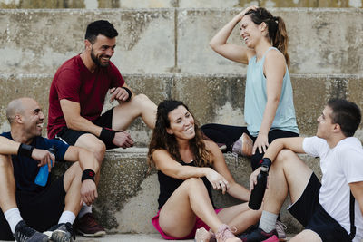 Group of athletes sitting relaxed after practicing crossfit.