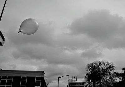 Low angle view of street light against cloudy sky