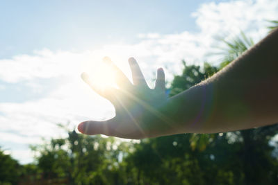 Hand against sky