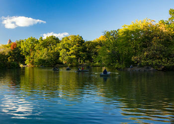 People sailing boat on river