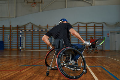 Rear view of man riding bicycle on street