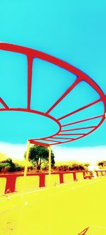 Low angle view of ferris wheel against blue sky