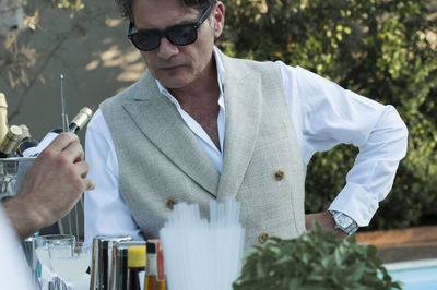 Mid adult man standing by bar counter at party