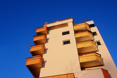 Low angle view of building against clear blue sky