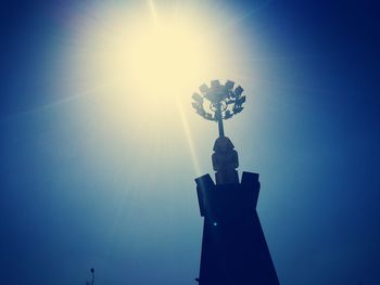 Low angle view of statue against clear blue sky