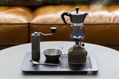 Close-up of coffee cup on table moka pot
