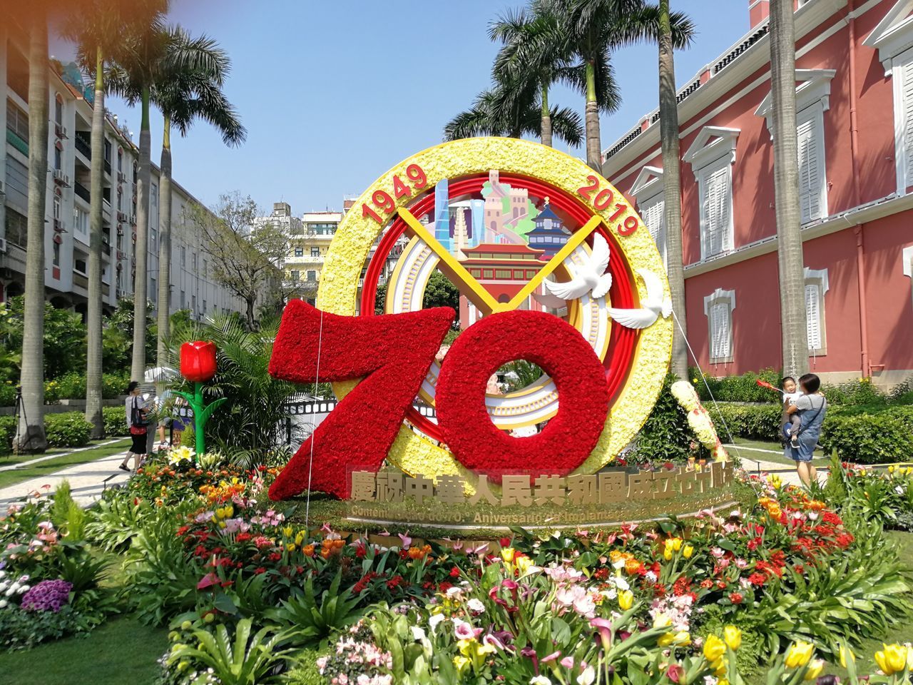 VIEW OF RED FLOWERING PLANTS BY BUILDING