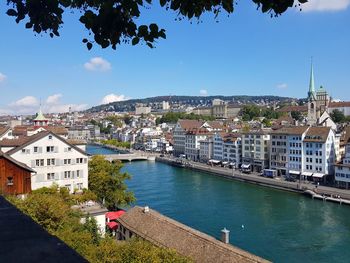 High angle view of river by buildings against sky