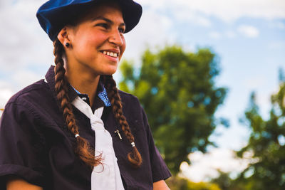 Side view of smiling teenage girl wearing beret