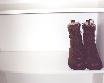 Close-up of shoes on shelf at home