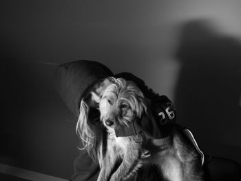 Close-up of woman with dog relaxing at home