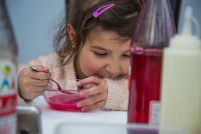 Close-up of small girl enjoying soup