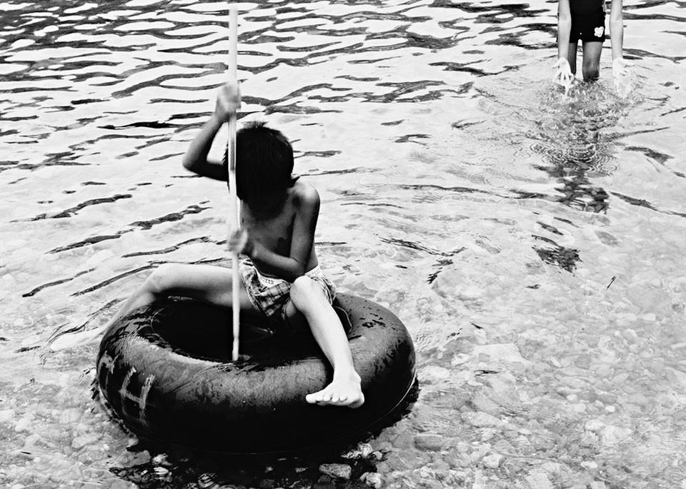 YOUNG WOMAN STANDING IN WATER