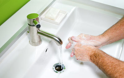 High angle view of hands in bathroom