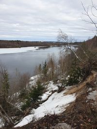 Scenic view of lake against sky during winter