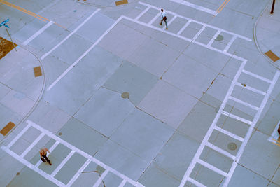 High angle view of people walking on footpath in city