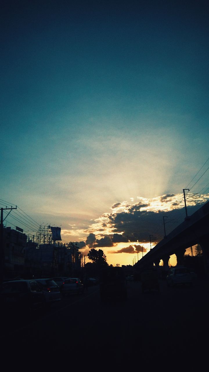 SILHOUETTE OF CITY STREET AGAINST SKY