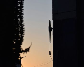 Low angle view of silhouette built structure against sky