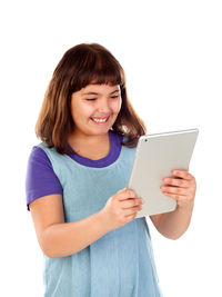 Smiling girl holding smart phone while standing against white background