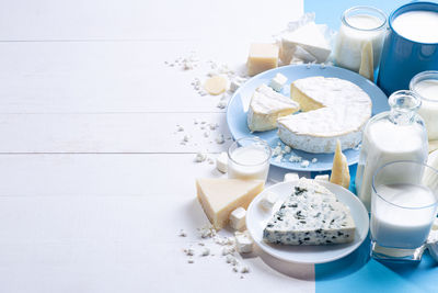 Dairy products on white wood base with copy space.