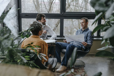 Happy business people having discussion in office