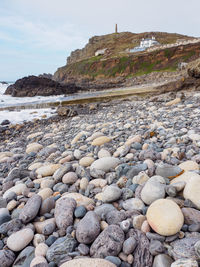 Rocks on beach against sky