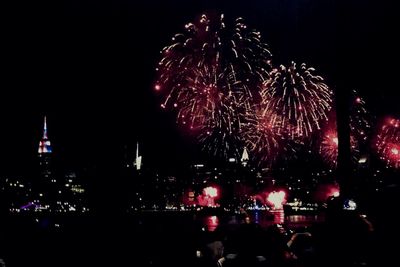 Low angle view of firework display at night