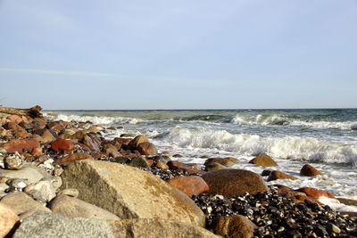 Rocks on beach against sky