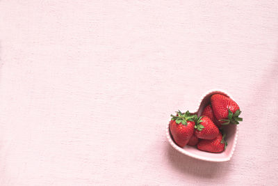 Directly above shot of strawberries on table against wall