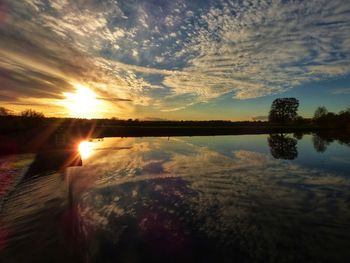 Scenic view of lake against sky during sunset