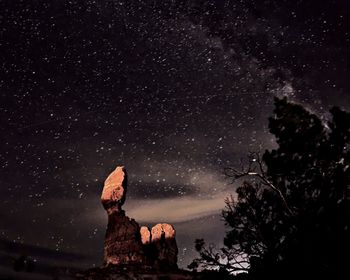 Low angle view of silhouette trees against sky at night