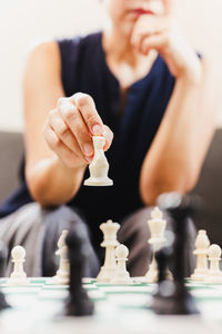 Midsection of woman playing chess