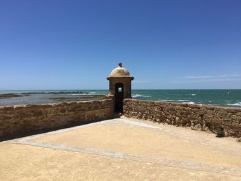 Scenic view of sea against clear blue sky