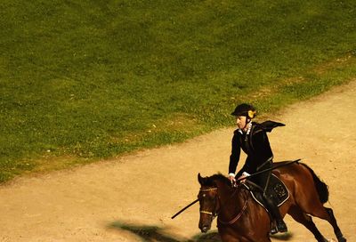 Man riding horse on field