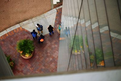 High angle view of people walking on staircase
