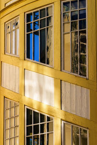 Low angle view of yellow windows on building
