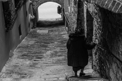 Full length of woman walking in tunnel